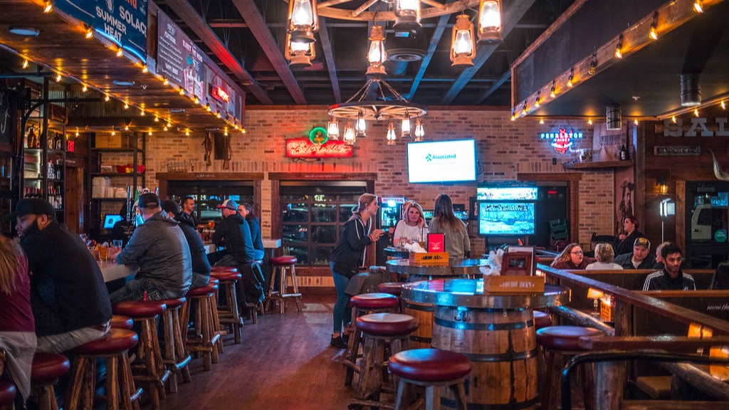 Inside the saloon: barrel tables, lantern lights and a full bar